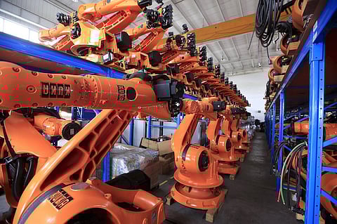 Robots are seen in a factory in Shanghai in this August 21, 2015 file photo. Activity in China's factory sector unexpectedly shrank to a 6-1/2 year low in September, a private survey showed, raising fears of a sharper slowdown in the world's second-largest economy that could spell more turmoil for financial markets. REUTERS/Aly Song/Files