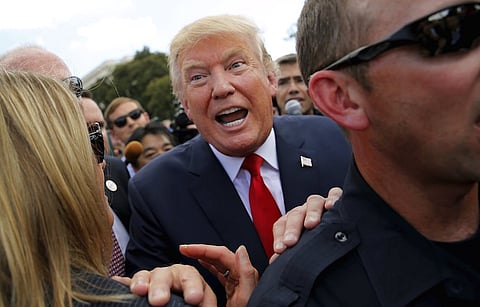 U.S. Republican presidential candidate Donald Trump makes his way through the crowd after addressing a Tea Party rally against the Iran nuclear deal at the U.S. Capitol in Washington September 9, 2015. REUTERS/Jonathan Ernst TPX IMAGES OF THE DAY