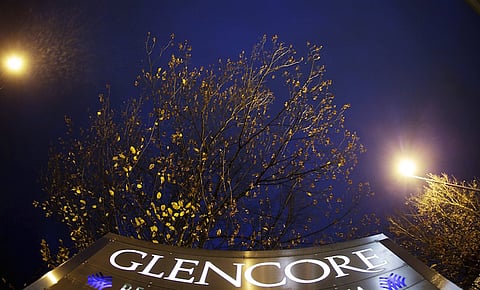 The logo of Glencore is pictured in front of the company's headquarters in the Swiss town of Baar, in this November 13, 2012 file photo. Shares in mining and trading company Glencore fell almost 30 percent and closed at a record low on Monday over concerns it is not doing enough to cut its debt to withstand a prolonged fall in global metals prices. About 3.5 billion pounds ($5.33 billion) in market value was wiped off the Swiss-based firm, whose $10 billion share offering in 2011 turned its managers into billionaire shareholders but left it saddled with debt - a growing problem as commodity prices fell. REUTERS/Michael Buholzer/Files
