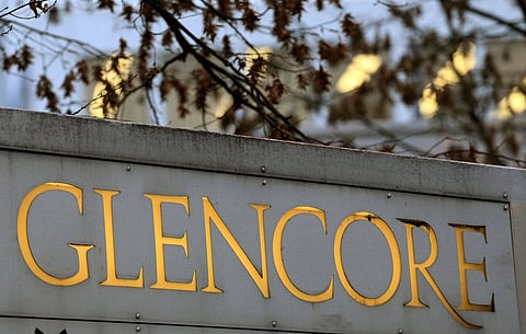 The logo of commodities trader Glencore is pictured in front of the company's headquarters in the Swiss town of Baar in this November 20, 2012 file photo. Shares in mining and trading company Glencore fell almost 30 percent and closed at a record low on Monday over concerns it is not doing enough to cut its debt to withstand a prolonged fall in global metals prices. About 3.5 billion pounds ($5.33 billion) in market value was wiped off the Swiss-based firm, whose $10 billion share offering in 2011 turned its managers into billionaire shareholders but left it saddled with debt - a growing problem as commodity prices fell.   REUTERS/Arnd Wiegmann/Files