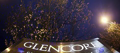 The logo of Glencore is pictured in front of the company's headquarters in the Swiss town of Baar, in this November 13, 2012 file photo. Shares in mining and trading company Glencore fell almost 30 percent and closed at a record low on Monday over concerns it is not doing enough to cut its debt to withstand a prolonged fall in global metals prices. About 3.5 billion pounds ($5.33 billion) in market value was wiped off the Swiss-based firm, whose $10 billion share offering in 2011 turned its managers into billionaire shareholders but left it saddled with debt - a growing problem as commodity prices fell. REUTERS/Michael Buholzer/Files