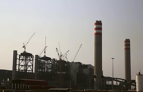Cranes sit beside the Medupi power station in Lephalale, as South African President Jacob Zuma arrives to open South Africa's first new power plant in 20 years, August 30, 2015. Construction on the six-unit, 4,764 MW plant was started in 2007 but the first 794 megawatts (MW) only came online this week after delays due to strikes, technical issues and cost overruns. REUTERS/Sydney Sheshibedi