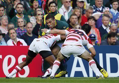File photo: Rugby Union - South Africa v Japan - IRB Rugby World Cup 2015 Pool B - Brighton Community Stadium, Brighton, England - 19/9/15
South Africa's Bryan Habana in action with Japan's Kotaro Matsushima (L) and Kosei Ono
Reuters / Eddie Keogh
Livepic