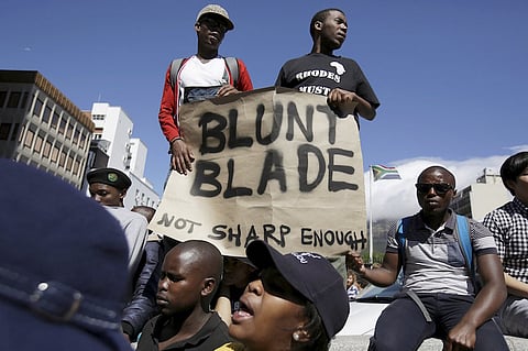 File photo: Students protest over planned increases in tuition fees outside South Africa's Parliament in Cape Town, October 21, 2015. Riot police fired tear gas and stun grenades on Wednesday at hundreds of protesting students who stormed the parliament precinct in Cape Town to try to disrupt the reading of Finance Minister Nhlanhla Nene's interim budget. REUTERS/Mark Wessels