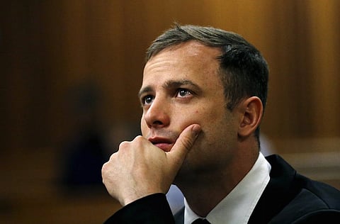 Olympic and Paralympic track star Oscar Pistorius is pictured ahead of his sentencing hearing at the North Gauteng High Court in Pretoria in this October 16, 2014 file photo. Pistorius was released on parole, a day ahead of his expected Oct. 20 date, about a year into his five-year sentence for killing his girlfriend Reeva Steenkamp, authorities said. The department of correctional services said in a statement on October 15, 2015 the Olympic and Paralympic track star would be placed under house arrest from Tuesday. REUTERS/Siphiwe Sibeko/Files