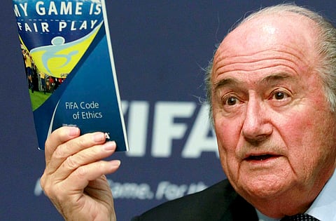 File photo of FIFA President Sepp Blatter displaying a brochure containing the FIFA code of ethics as he addresses a news conference at the FIFA headquarters in Zurich, Switzerland  May 30, 2011. The Ethics Committee of the scandal-hit body was given the right to disclose information about cases by FIFA's executive committee October 20, 2015 and wasted no time in taking advantage of its new freedom.  German football great Franz Beckenbauer on Wednesday became the latest FIFA official named as under investigation, along with FIFA vice-president Angel Maria Villar and several other former executive committee members.  REUTERS/Arnd Wiegmann/Files