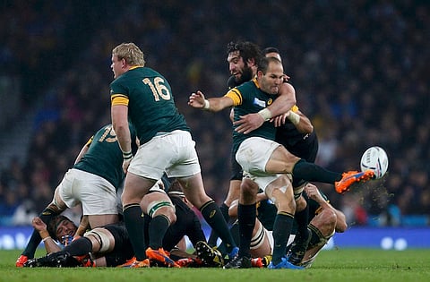 Fourie Du Preez of South Africa (R) kicks the ball as he is tackled by Samuel Whitelock of New Zealand during their Rugby World Cup Semi-Final match at Twickenham in London, Britain, October 24, 2015. REUTERS/Russell Cheyne