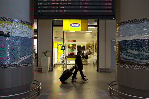 Travellers walk past an MTN telecom shop at King Shaka International Airport in Durban, South Africa, November 16, 2015.