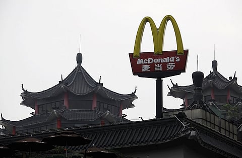 A McDonald's sign is displayed outside its outlet, the first one which opened in China in 1990, at the southern Chinese city of Shenzhen neighbouring Hong Kong in this March 18, 2013 file photo. McDonald's China sales at restaurants open at least 13 months, which had plummeted after a food safety scandal in July 2014, were up a whopping 26.8 percent for the quarter, helped by a focus on value and breakfast. REUTERS/Bobby Yip/Files