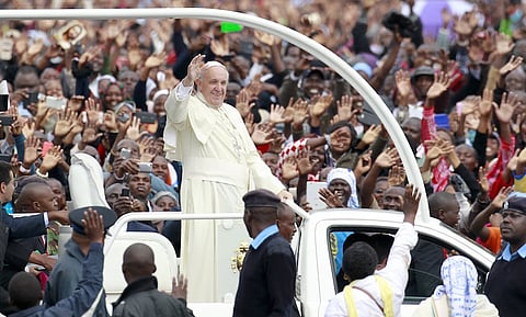 Pope Francis waves to faithful while riding in an open truck as he arrives for a Papal mass in Kenya's capital Nairobi, November 26, 2015. In actions and words on his first tour of the world's poorest continent, Pope Francis has sent a message to African leaders that they could do with less pomp and a bit more humility. Francis, who has spurned many of the institutional perks of the Vatican, shunned the armoured cars with tinted glass driven by President Uhuru Kenyatta and his entourage. REUTERS/Thomas Mukoya