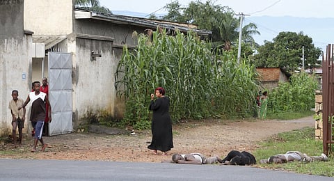 Residents look at the bodies of unidentified men killed during gunfire, in the Nyakabiga neighbourhood of Burundi's capital Bujumbura, December 12, 2015. At least 20 dead bodies were seen on the streets of the Burundian capital Bujumbura on Saturday, a police source said, following the worst outbreak of violence since a failed coup in May. REUTERS/Jean Pierre Aime Harerimana