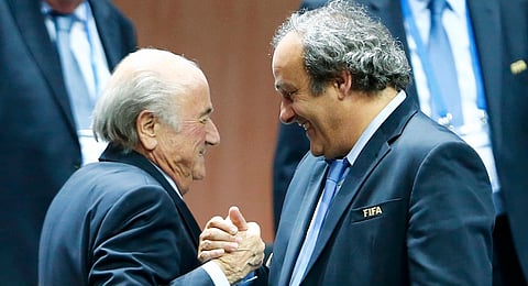 File picture of UEFA President Michel Platini (R) congratulating FIFA President Sepp Blatter after he was re-elected at the 65th FIFA Congress in Zurich, Switzerland, May 29, 2015. Suspended FIFA President Blatter and European soccer boss Platini were both banned for eight years December 21, 2015 by FIFA's Ethics Committee. The pair, who have also been fined, had been suspended for 90 days in October while an investigation was carried out into a 2 million Swiss franc ($2.02 million) payment by FIFA to Platini in 2011. Both men have denied any wrongdoing. REUTERS/Arnd Wiegmann