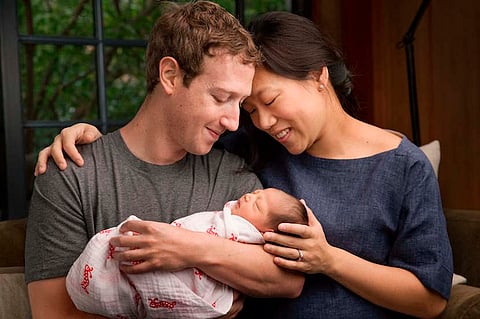Facebook Chief Executive Mark Zuckerberg and his wife Priscilla are seen with their daughter named Max in this image released on December 1, 2015. Zuckerberg and his wife said they plan to give away 99 percent of their fortune in Facebook stock to a new charity the couple were creating, while announcing the birth of their first child on Tuesday. REUTERS/Courtesy of Mark Zuckerberg/Handout