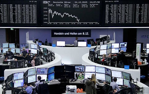Traders are pictured at their desks in front of the DAX board at the stock exchange in Frankfurt, Germany. REUTERS/Staff/Remote.