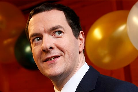 Britain's Chancellor of the Exchequer George Osborne looks up during a tour of Small Business Saturday Christmas Fair at the Treasury in London, Britain. REUTERS/Stefan Wermuth.