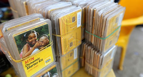 Packets of MTN sim cards sit for sale at a roadside kiosk in Lagos, Nigeria. Africa's largest wireless operator remains in negotiations with Nigerian regulators over a $5.2 billion fine for failing to comply with an order to disconnect customers with unregistered phone cards, according to a person familiar with the matter. Photographer: George Osodi/Bloomberg