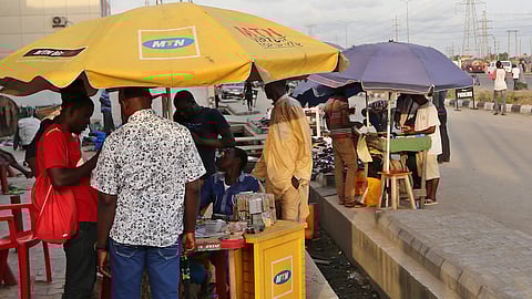 File photo: Customers register their MTN Group mobile phone sim cards at a roadside kiosk in Lagos, Nigeria, on Saturday, Oct. 31, 2015. Photographer: George Osodi/Bloomberg