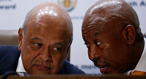 South Africa's Finance Minister, Pravin Gordhan (L) chats with Lesetja Kganyago, Governor of the Reserve Bank of South Africa, during a media briefing after Gordhan was reappointed to the position by President Jacob Zuma, in Pretoria, South Africa. REUTERS/Siphiwe Sibeko