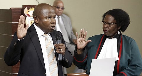 Justice Sisi Khampepe (R) swears in South Africa's new Finance Minister David van Rooyen as South Africa's President Jacob Zuma (C) looks on during a ceremony at the Union building in Pretoria, December 10, 2015. REUTERS/Sydney Seshibedi