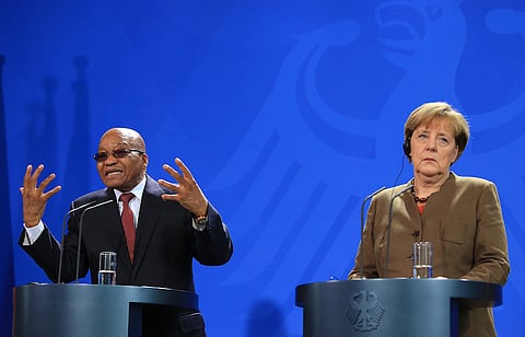 Jacob Zuma, South Africa's president, left, gestures as he speaks during a news conference with Angela Merkel, Germany's chancellor, at the Chancellery in Berlin, Germany, on Tuesday, Nov. 10, 2015. European Union President Donald Tusk said Germany needs to make it clear that Europe's ability to absorb refugees is limited, challenging Merkel to signal toughness alongside moral principles. Photographer: Krisztian Bocsi/Bloomberg *** Local Caption *** Angela Merkel; Jacob Zuma