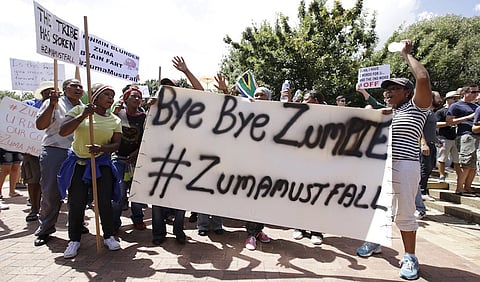 Protesters carry placards as they take part in a demonstration against President Jacob Zuma in Cape town, South Africa, December 16, 2015. REUTERS/Mark Wessels