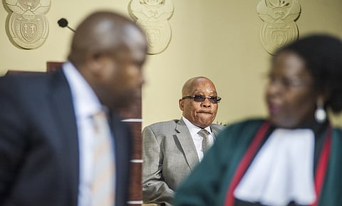 Jacob Zuma, South Africa's president, center, watches as David van Rooyen, South Africa's incoming finance minister, left, is sworn into office by Sisi Virginia Khampepe, a judge, at the Union Buildings in Pretoria, South Africa, on Thursday, Dec. 10, 2015. The rand fell for a sixth day in the longest streak of losses since November 2013, stocks slid and bond prices tumbled the most on record after South African President Jacob Zuma fired Finance Minister Nhlanhla Nene and replaced him with a little-known lawmaker. Photographer: Waldo Swiegers/Bloomberg