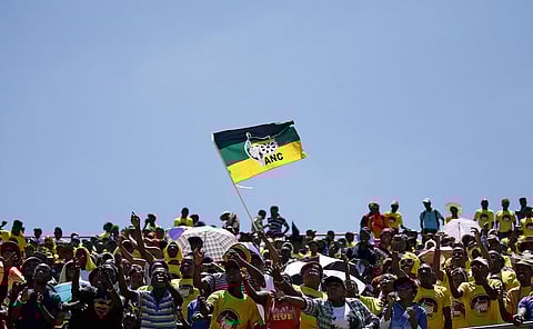 Supporters of the African National Congress (ANC) wave a party flag during the party's 104th anniversary celebrations in Rustenburg, South Africa January 9, 2016. REUTERS/Siphiwe Sibeko