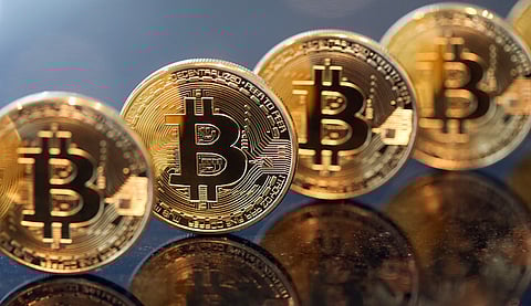 A collection of bitcoins stand in this arranged photograph in London, U.K., on Friday, Jan. 29, 2016. The International Monetary Fund extolled the potential benefits of virtual currencies and said they warrant a more nuanced regulatory approach, at a time when the future of bitcoin, the most well-known example, is in doubt's. Bitcoin traded at about $379 on Jan. 20, about a third of its peak in 2013. Photographer: Chris Ratcliffe/Bloomberg