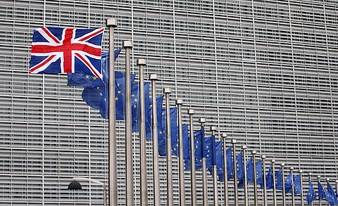 A Union Jack flag flutters next to European Union flags ahead of a visit from Britain's Prime Minister David Cameron at the EU Commission headquarters in Brussels, Belgium, January 29, 2016. REUTERS/Francois Lenoir