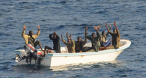 090211-N-1082Z-111
GULF OF ADEN (Feb. 11, 2009) Suspected pirates keep their hands in the air as directed by the guided-missile cruiser USS Vella Gulf (CG 72) as the visit, board, search and seizure (VBSS) team prepares to apprehend them. Vella Gulf is the flagship for Combined Task Force 151, a multi-national task force conducting counterpiracy operations to detect and deter piracy in and around the Gulf of Aden, Arabian Gulf, Indian Ocean and Red Sea. It was established to create a maritime lawful order and develop security in the maritime environment. (U.S. Navy photo by Mass Communications Specialist 2nd Class Jason R. Zalasky/Released)