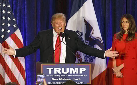 Donald Trump, president and chief executive of Trump Organization Inc. and 2016 Republican presidential candidate, left, speaks on stage as his wife Melania Trump looks on during a caucus watch party in West Des Moines, Iowa, U.S., on Monday, Feb. 1, 2016. Republicans looking for a candidate who could stop Trump found one on Monday evening, as U.S. Senator Ted Cruz emerged from a brutal campaign with a victory in the first-in-the-nation caucuses. Photographer: Patrick T. Fallon/Bloomberg