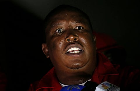 Economic Freedom Fighters (EFF) party leader Julius Malema speaks to journalists after being ordered to leave the parliamentary chamber during President Jacob Zuma's State of the Nation address in Cape Town, February 11, 2016. REUTERS/Mike Hutchings