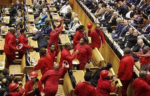 Members of the opposition Economic Freedom Fighters (EFF) party leave the parliamentary chamber as South Africa's President Jacob Zuma delivers his State of the Nation address in Cape Town, February 11, 2016.  REUTERS/Schalk van Zuydam