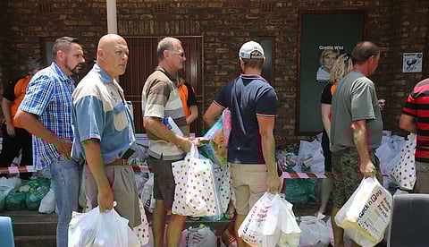Retrenched Highveld Steel workers queue for food hampers. Photo: Reint Dykema