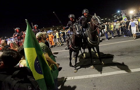 Police officers control demonstrators during a protest against President Dilma Rousseff's appointment of former President Luiz Inacio Lula da Silva as her chief of staff, in front of the Brazilian national congress in Brasilia, Brazil, March 17, 2016. REUTERS/Ricardo Moraes