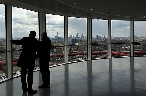 Visitors view the City of London from Queen Elizabeth Olympic Park in London, Britain, April 26, 2016. REUTERS/Toby Melville