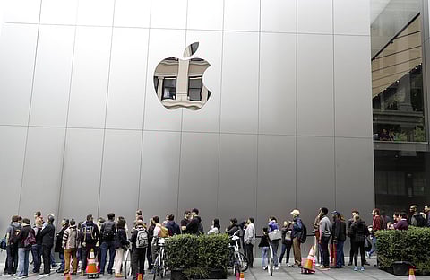 People wait in line for the opening of the next generation Apple Store in San Francisco, California, U.S. May 21, 2016. REUTERS/Stephen Lam
