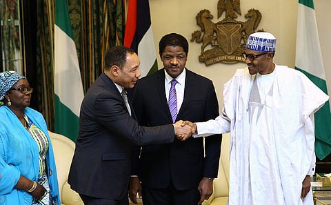 Nigeria's President Muhammadu Buhari shakes hands with Edward Singhatey, Vice President of the Economic Community of West African States Commision, as Marcel A. De Souza, President of ECOWAS Commision, and Mrs Halima Ahmed Commissioner for Political Affairs, Peace and Security look on, during a visit in Abuja, Nigeria May 26, 2016. REUTERS/Stringer.