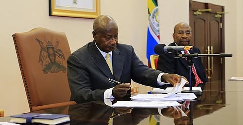 Uganda's President Yoweri Museveni signs an anti-homosexual bill into law at the state house in Entebbe, 36 km (22 miles) southwest of the capital Kampala February 24, 2014. REUTERS/James Akena