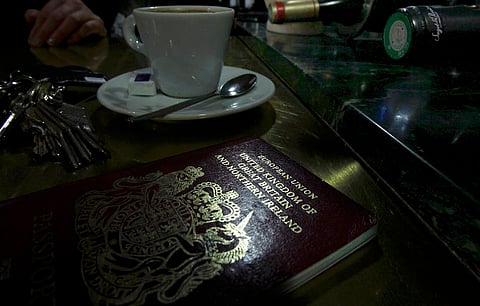 File photo illustration shows a European Union British Passport on the counter of a cafe in Paris, France, January 23, 2013. Carmakers and soccer chiefs threw their weight behind the campaign for Britain to stay in the European Union June 20, 2016, as opinion polls showing the "Remain" camp gaining ground buoyed shares and sterling three days ahead of the referendum. REUTERS/Mal Langsdon/File Photo