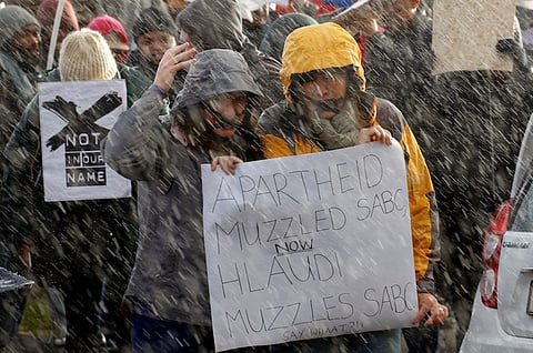 Demonstrators protest in the rain against the decision by public broadcaster the South African Broadcasting Corporation (SABC) that it would not broadcast scenes of violent protest, in Cape Town, South Africa, July 1, 2016.  REUTERS/Mike Hutchings