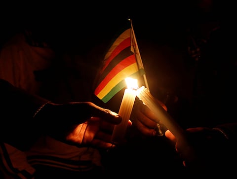 Zimbabwean Pastor Evan Mawarire's followers light candles after his release at Harare Magistrates court, July 13, 2016. REUTERS/Philimon Bulawayo