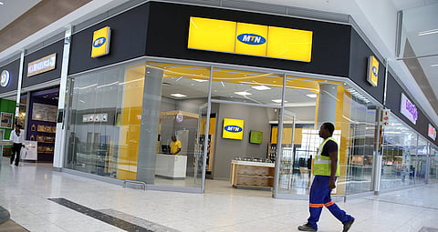 A worker walks past an outlet of South Africa's MTN Group in Johannesburg, South Africa, February 23, 2016. REUTERS/Siphiwe Sibeko/File Photo