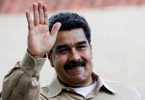President Nicolas Maduro of Venezuela waves while he waits the arrival of Colombia's President Juan Manuel Santos at Macagua Hydroelectric compound in Puerto Ordaz, Venezuela, August 11, 2016. REUTERS/Carlos Garcia Rawlins