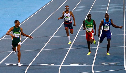 2016 Rio Olympics - Athletics - Final - Men's 400m Final - Olympic Stadium - Rio de Janeiro, Brazil - 14/08/2016. Wayde van Niekerk (RSA) of South Africa crosses the finish line to win the race REUTERS/David Gray