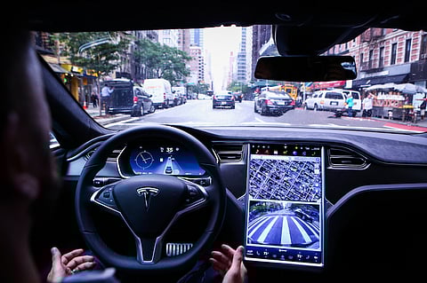 A driver rides hands-free in a Tesla Motors Inc. Model S vehicle equipped with Autopilot hardware and software in New York, U.S. on Monday, Sept. 19, 2016. The latest overhaul of the car's operating system, known as Tesla 8.0, biggest change is how Autopilot shifts towards a heavier reliance on its radar than its camera to guide the car through traffic. Photographer: Christopher Goodney/Bloomberg