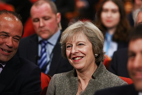 Theresa May, U.K. prime minister and leader of the Conservative Party, listens to speeches on the second day of the party's annual conference in Birmingham, U.K., on Monday, Oct. 3, 2016. Business groups and foreign capitals pressed May for more detail after she said she'll start pulling the U.K. out of the European Union in the first quarter of 2017, and hinted that she's tending toward a so-called hard Brexit. Photographer: Chris Ratcliffe/Bloomberg