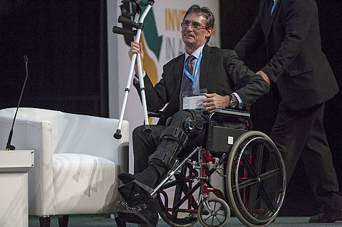 Christopher Griffith, chief executive officer of Anglo American Platinum Ltd., arrives on stage in a wheelchair for a panel discussion on the second day of the Investing in African Mining Indaba in Cape Town, South Africa, on Tuesday, Feb. 7, 2017. A mix of shrinking reserves, rising labor costs, frequent stoppages and regulatory uncertainty has prompted major miners to rethink their presence in the country, home to the world’s largest platinum, chrome, and manganese reserves and the source of one-third of all gold ever mined. Photographer: Halden Krog/Bloomberg