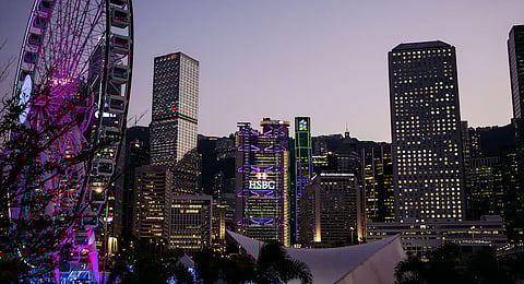 The HSBC Holdings Plc headquarters, center, and the Standard Chartered Bank building, center right, stand illuminated at dusk in the Central district of Hong Kong, China, on Monday, Feb. 13, 2017. HSBC is scheduled to release earnings results on Feb. 21. Photographer: Anthony Kwan/Bloomberg