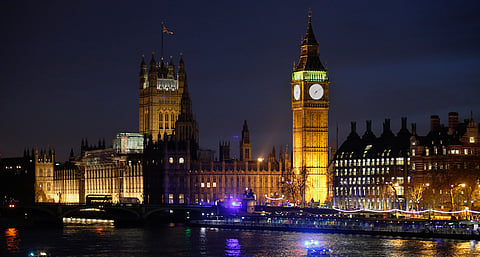 The Elizabeth Tower, commonly refereed to as Big Ben, stands illuminated at dusk as ambulances stand with other emergency service vehicles on Westminster Bridge, beside the Houses of Parliament following an incident in central London, U.K., on Wednesday, March 22, 2017. Multiple shots were fired near the U.K. Parliament on Wednesday in London during an incident that also saw people hit by a car on Westminster Bridge. Photographer: Luke MacGregor/Bloomberg